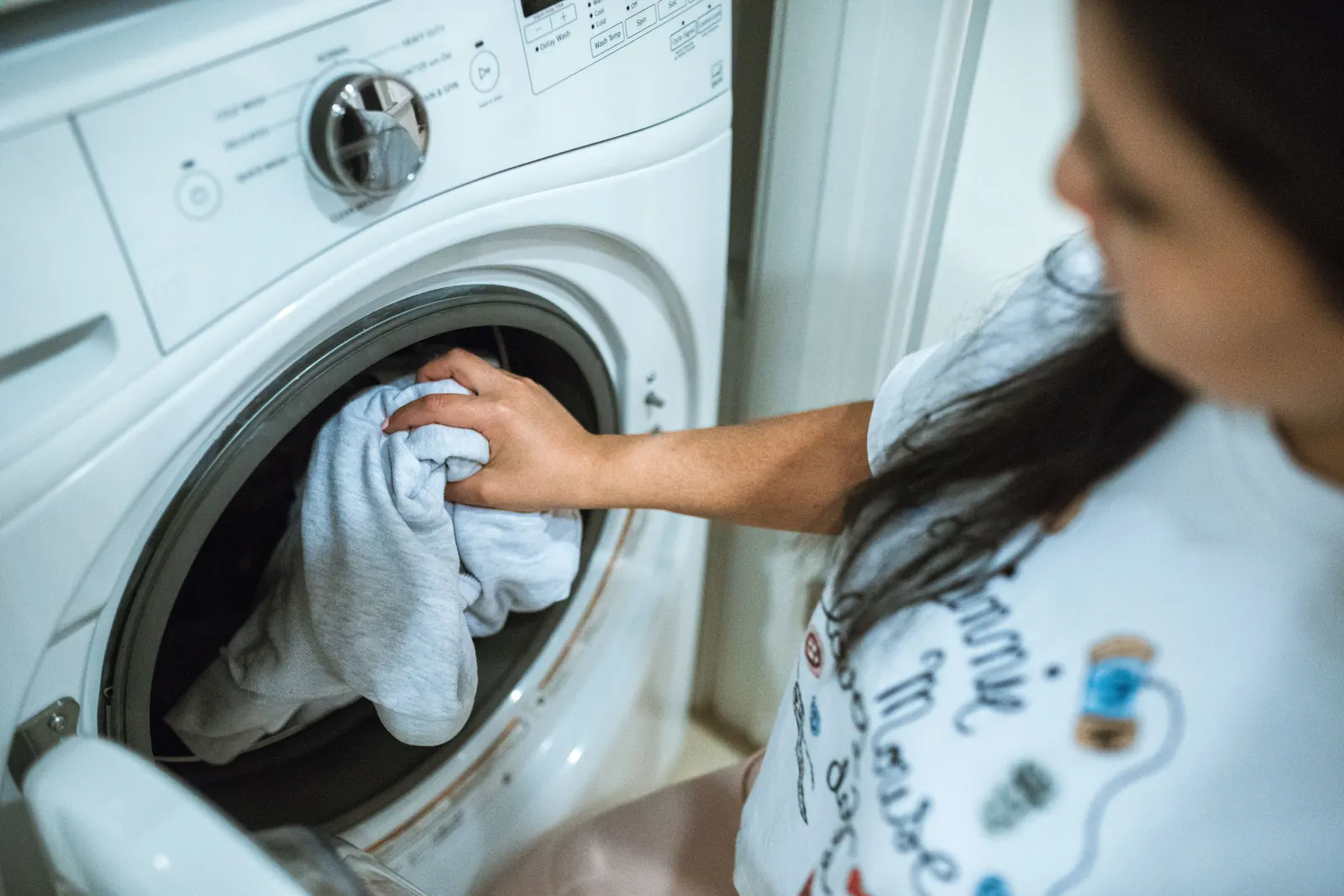 Laundry being placed in a household washing machine